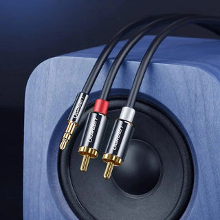 Audio cable with different connectors on a blue speaker