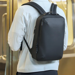 Person wearing a black backpack in an indoor setting