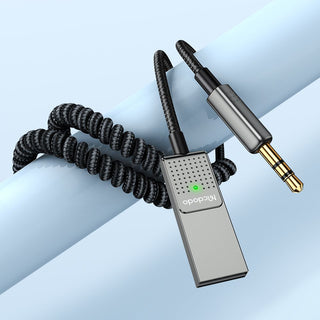 Audio adapter with coiled cable on a light blue background