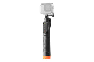 A black handheld gimbal selfie stick with an orange accent at the bottom and a clear protective housing around a camera mounted at the top, shown on a plain white background.