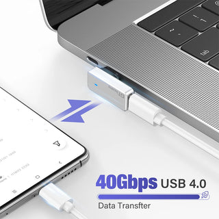 USB 4.0 adapter connected to a laptop with smartphone on a white background
