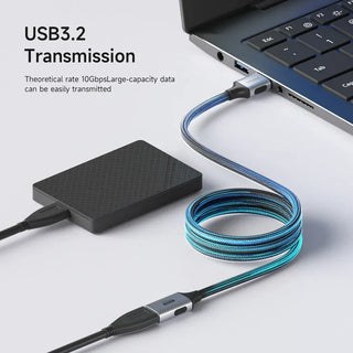 USB 3.2 transmission cable connected to a laptop and external hard drive on a light gray background.