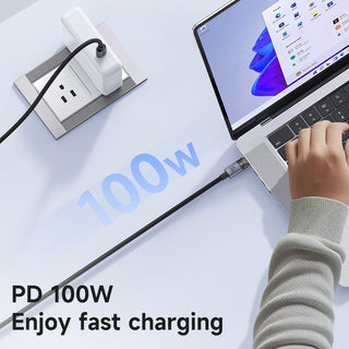 A 100W PD fast-charging cable connected to a laptop, shown with a hand using the trackpad and a wall outlet in the background. Text on the image reads 'PD 100W Enjoy fast charging'.