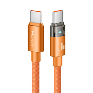 An orange Mcdodo 100W USB-C to USB-C charging cable on a solid white background, showing both connector ends with metallic silver USB-C interfaces and textured orange braided cords.