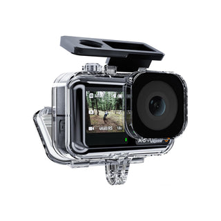 A clear waterproof housing case for an action camera, shown with a black pop-up screen cover attached and the rear display turned on. The housing is transparent with black and silver details, photographed on a solid white background.