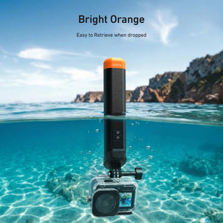 A waterproof camera retrieval pole in bright orange and black is shown in clear ocean water with a camera attached at the bottom. Text at the top reads 'Bright Orange' and 'Easy to Retrieve when dropped.