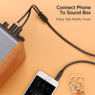 A black audio adapter cable shown connecting a smartphone to a sound box, with text reading 'Connect Phone To Sound Box' and 'Enjoy high fidelity music' on a peach background.