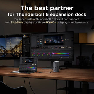 Thunderbolt 5 expansion dock setup on a desk with multiple monitors and laptop.